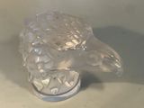 a glass sculpture of a turtle that is on a table
