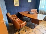 a desk with a chair and a computer on it in a room