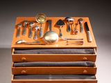 a stack of wooden drawers with silverware in it