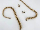 a close up of a gold chain with a hook on it