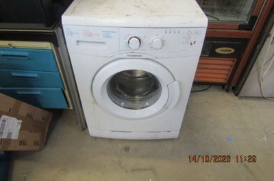 a washing machine that is sitting on the floor