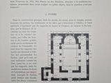 an open book with a drawing of a floor plan and a picture of a building