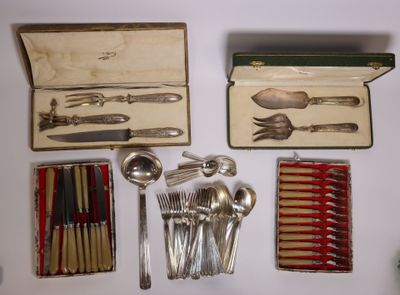 many different types of silverware in a box on a table