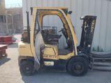 a forklift that is parked in front of a building