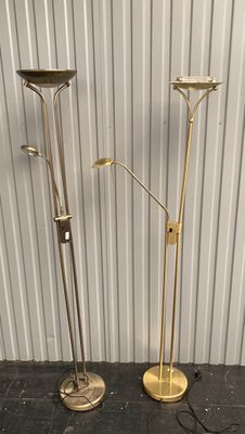 pair of brass floor lamps in the style of person