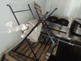 a kitchen with a stove and a rack with pots and pans on it