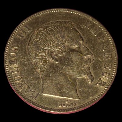 l'image d'une pièce d'or sur laquelle figure le visage d'une femme