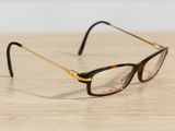 a pair of glasses sitting on a wooden table
