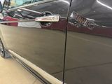 a close up of a car door handle with a sticker on it