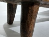 a wooden bench that is sitting on a white floor