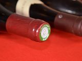 several bottles of wine are lined up on a red surface