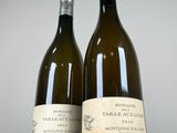 two bottles of wine sitting next to each other on a table