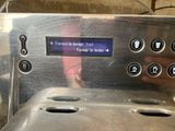 a close up of a coffee machine with buttons on it