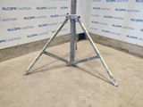 an image of a metal tripod in front of a wall