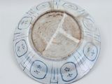 a white plate with a blue and white design on it
