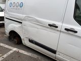 a white van that has been vandalized in a parking lot