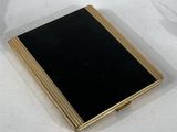 a black and gold book sitting on a white table