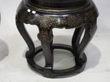 two black and gold vases sitting on a table