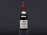 a bottle of wine sitting on top of a glass table