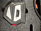 a close up of a car ' s engine cover on the floor
