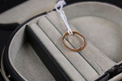 a wedding ring in a ring case with a white string