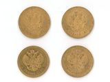 three gold sovereigns, one of which has a crown and the other of which is an eagle