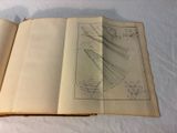 an open book with a drawing on it on a bed