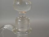 a clear glass bottle with a glass stopper on it