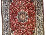a red and blue rug with a medallion design on a white background