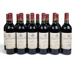 six bottles of wine are lined up on a white surface