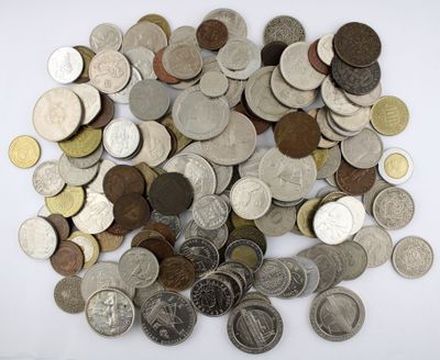 a pile of coins sitting on a white surface