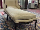 a chaise lounger sitting on a rug in a living room