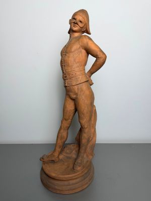 sculpture of a woman standing on a pedestal with her hands on her hips