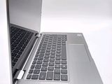 a silver laptop with a black keyboard on a white surface