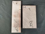 two pieces of wood with writing on them on a table
