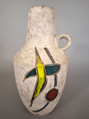 a white vase with a colorful design on it