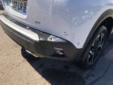 a white car that is parked in a parking lot