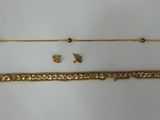 a collection of gold jewelry including a bracelet, bracelet, and earring