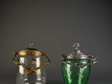 two glass jars that are sitting next to each other