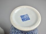 a blue and white vase with a blue and white design on it