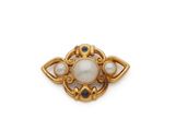 a close up of a brooch with pearls and sapphires