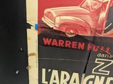 a poster of a car on the wall of a building