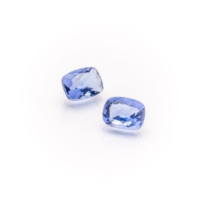 a pair of tanzanite gems on a white background