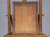 an old wooden easel with a wooden frame on a stand