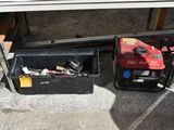 two tools sitting in a box on the ground