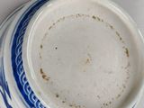a close up of a blue and white bowl on a table