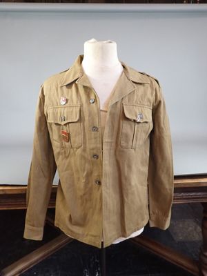 an image of a jacket on a mannequin stand in front of a painting