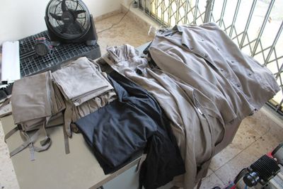 an image of a messy room with a laptop and a pile of clothes