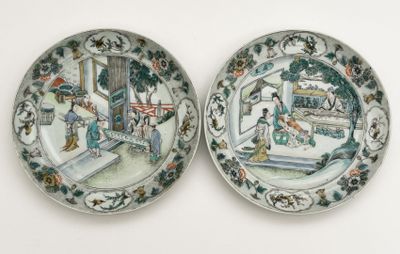 two plates with a painting on them are sitting on a table