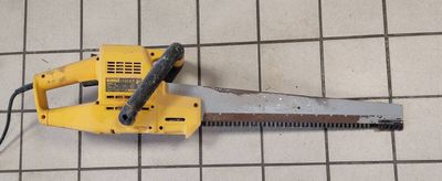 a saw on the floor with a cord attached to it